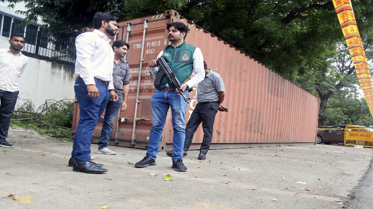 Heroin consignment Special Cell members stand guard near a container with more than 20,000 kg of licorice root coated with heroin that was seized from JNPT Port in Mumbai | ANI