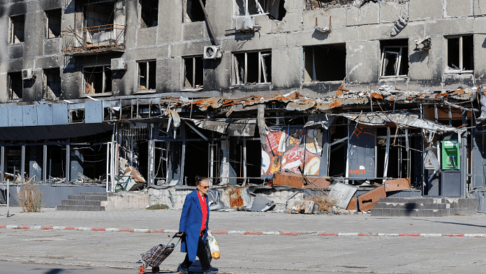 A local resident walks past an apartment block damaged in the course of Russia-Ukraine conflict in Mariupol, Ukraine September 25, 2022 |Source: Reuters.