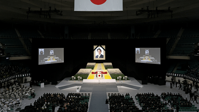 A portrait of Shinzo Abe hangs above the stage during the state funeral in Tokyo | Source: Reuters