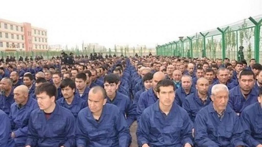 Detainees in a Xinjiang 're-education camp' located in Lop County listening to "de-radicalisation" talks | Wikimedia Commons