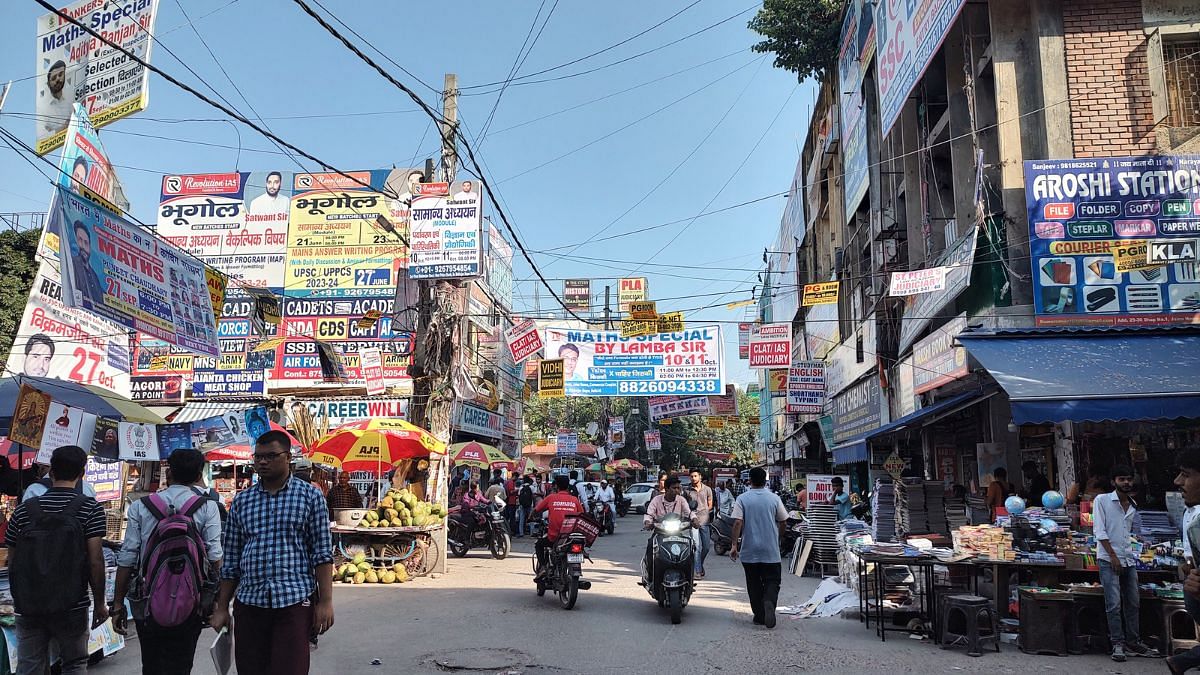 A visual of one of the busy bylanes in Mukherjee Nagar, Delhi, decorated with banners of coaching classes of UPSC and other competitive exams | Photo: Nidhima Taneja/ThePrint