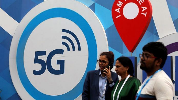 People stand in front of a board depicting 5G network at the India Mobile Congress 2018 in New Delhi | Reuters file photo
