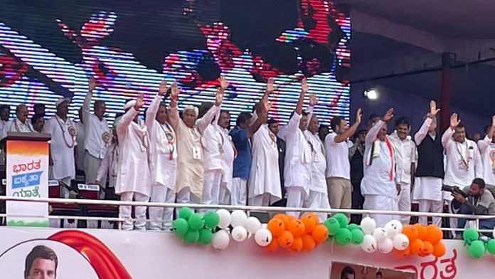 Congress leaders Rahul Gandhi and Mallikarjun Kharge along with party colleagues wave at supporters in Bellary, Karnataka | Photo: Abantika Ghosh | ThePrint