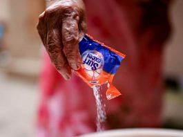 A woman pours a plastic sachet of Unilever's Surf Excel laundry detergent into a bucket | Representational image | Reuters