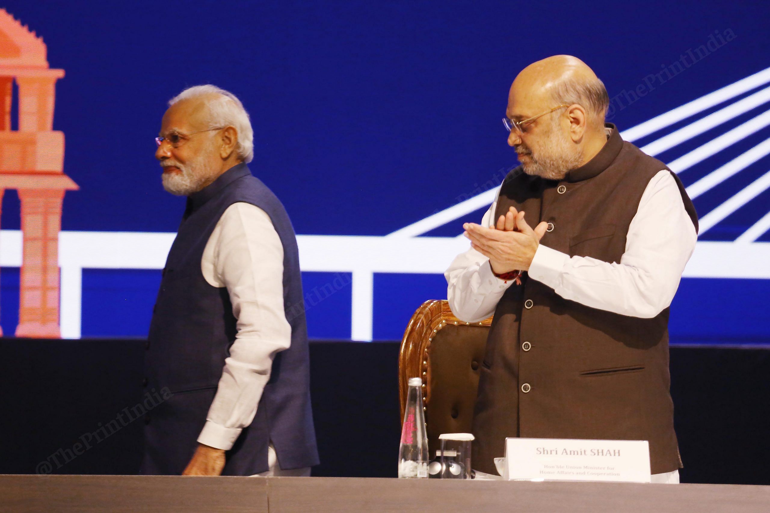 Union Home Minister Amit Shah claps while PM Narendra Modi going to address during the 90th General Assembly of INTERPOL at Pragati Maidan | Photo: Praveen Jain | ThePrint