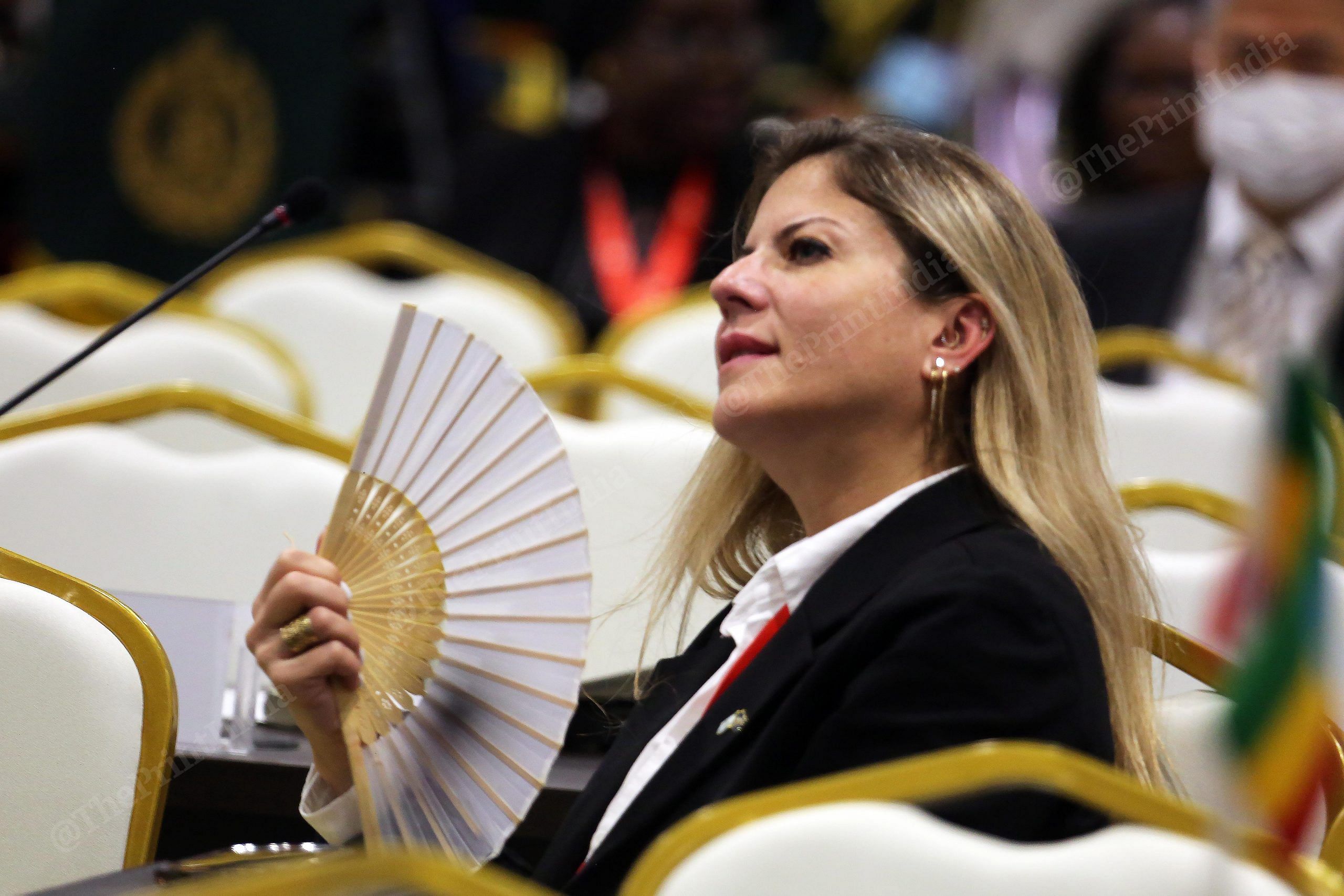 Delegate using a handmade fan during the 90th General Assembly of INTERPOL at Pragati Maidan | Photo: Praveen Jain | ThePrint