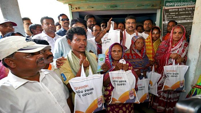 File photo of Union Minister Dharmendra Pradhan distributing rice to PMGKAY beneficiaries at a PDS centre | ANI