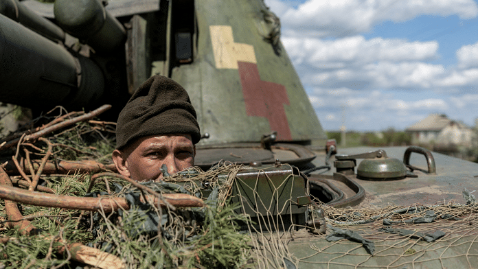 A Ukrainian soldier looks out from a tank, amid Russia's invasion of Lyman in April | Source: Reuters/Jorge Silva