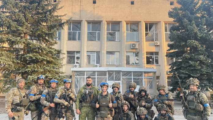 Ukrainian troops pose for a photo in Lyman, in a picture shared on social media | Courtesy of Oleksiy Biloshytskyi/via Reuters