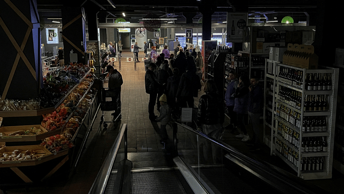 People visit in a supermarket without electricity, after a Russian missile attack, as Russia's invasion of Ukraine continues, in Kyiv, Ukraine 22 October, 2022. Reuters/Gleb Garanich