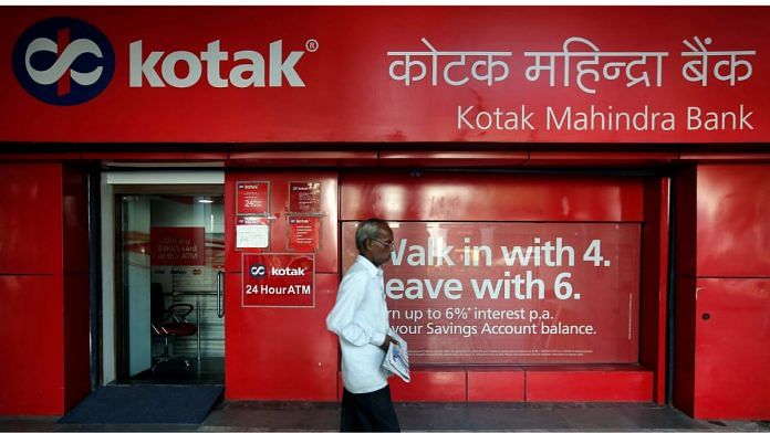 File photo of a man walking past the Kotak Mahindra Bank branch in New Delhi, India, 6 September, 2017. | Reuters