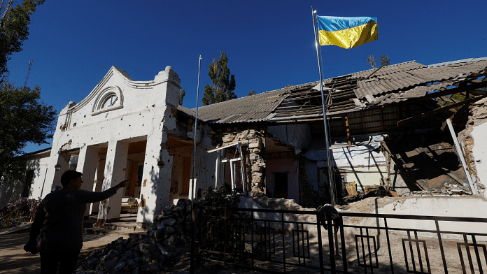 A Ukrainian national flag rises over a local council's headquarter building, heavily damaged during Russia's attack in the village of Lymany near a frontline in Mykolaiv region, Ukraine 18 October, 2022. Reuters/Valentyn Ogirenko