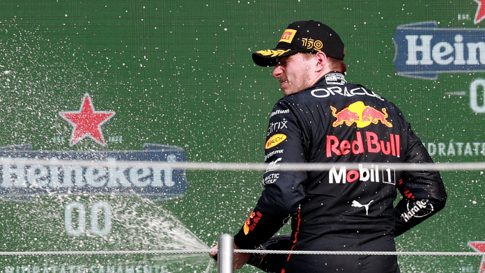 Red Bull's Max Verstappen celebrates on the podium after winning the race and setting a new F1 record of 14 grand prix wins in a season Reuters/Henry Romero