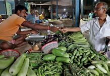 File photo of Nikhil Kumar Mondal, 65, a retired school headmaster, buys vegetables from a vendor at a market on the outskirts of Kolkata, India, 20 May, 2022. | Reuters