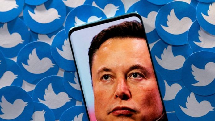 File photo of an image of Elon Musk seen on a smartphone placed on printed Twitter logos | Reuters