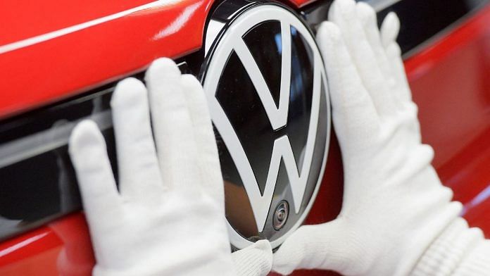 File photo of technician attaching a Volkswagen logo to a car, at the production line for electric car models of the Volkswagen Group, in Zwickau, Germany, 26 April, 2022 | Reuters