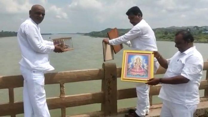 Venkatesh Hosmani, 49, and others throw photos of Hindu gods in a river in Karnataka’s Yadgir district | By special arrangement