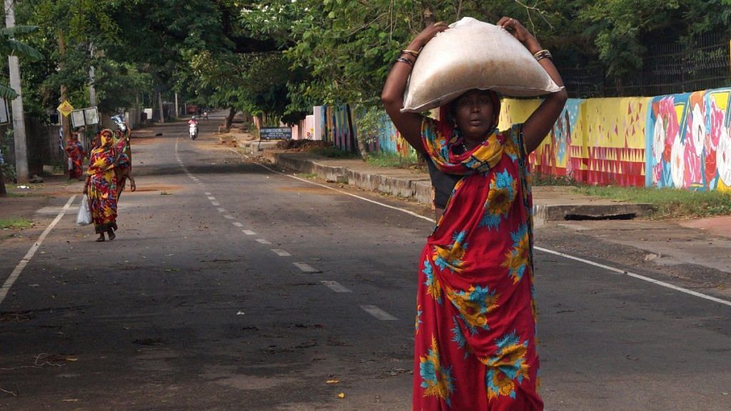 File photo of Below Poverty Line beneficiaries carrying rations collected from a Public Distribution System centre during the nationwide lockdown in the wake of the pandemic, in Odisha's Bhubaneswar | Representational image | ANI