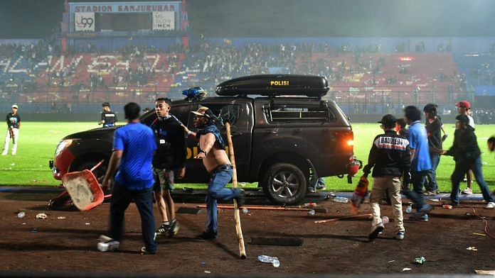 Supporters enter the field after the football match between Arema vs Persebaya at Kanjuruhan Stadium, Malang, East Java province, Indonesia, on 2 October 2022 | Reuters