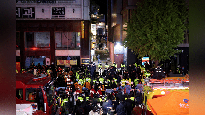 Rescue team and firefighters work at the scene where dozens of people were injured in a stampede during a Halloween festival in Seoul, South Korea, 30 October, 2022. Photo: Reuters/Kim Hong-ji