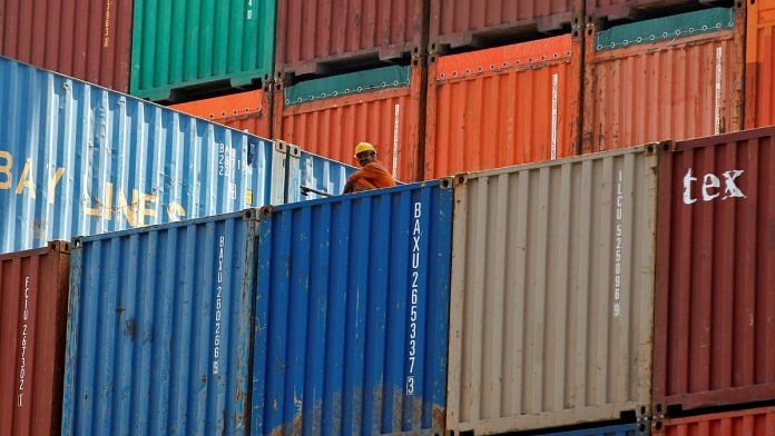 A worker sits on a ship carrying containers at Mundra Port in the western Indian state of Gujarat | Reuters/Amit Dave/File Photo