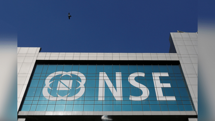 FILE PHOTO: A bird flies past the logo of National Stock Exchange (NSE) installed on the facade of its building in Mumbai, India, February 9, 2018. REUTERS/Danish Siddiqui