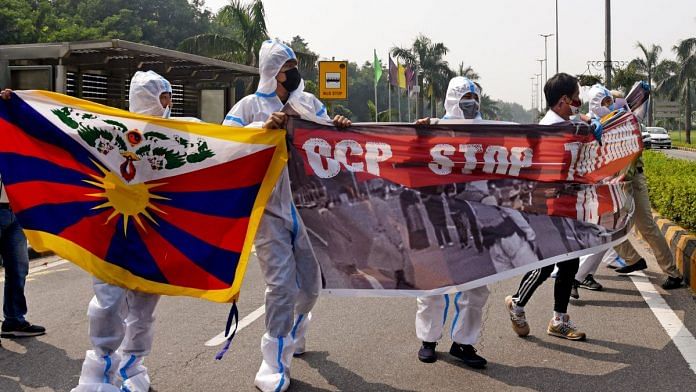 Tibetan Youth Congress (TYC) supporters wearing PPE stage a protest in front of the Chinese Embassy in New Delhi, on 1 October 2022 | ANI photo