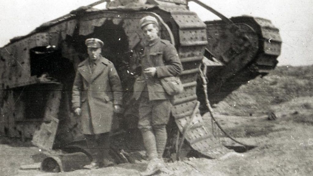 Two soldiers standing beside First World War tank with one track broken and hole blown in side | Representational image | Flickr