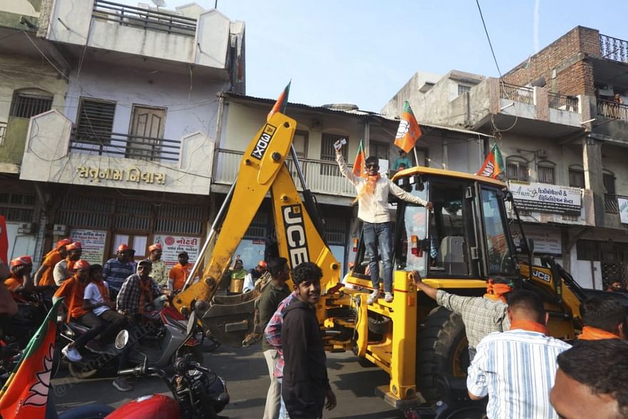 A bulldozer, which the Adityanath government has used as a tool against alleged corruption and land grab, was part of the UP CM's roadshow in Godhra | Photo: Praveen Jain | ThePrint