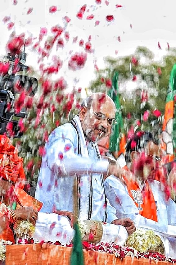 The union home minister is showered with flower petals | Photo: Praveen Jain | ThePrint