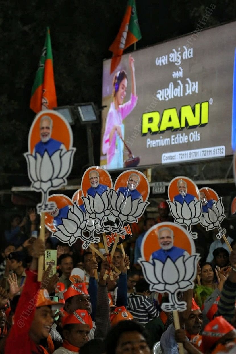 BJP suppporters holding placards with PM Modi's picture and BJP symbol on them | Photo: Praveen Jain | ThePrint