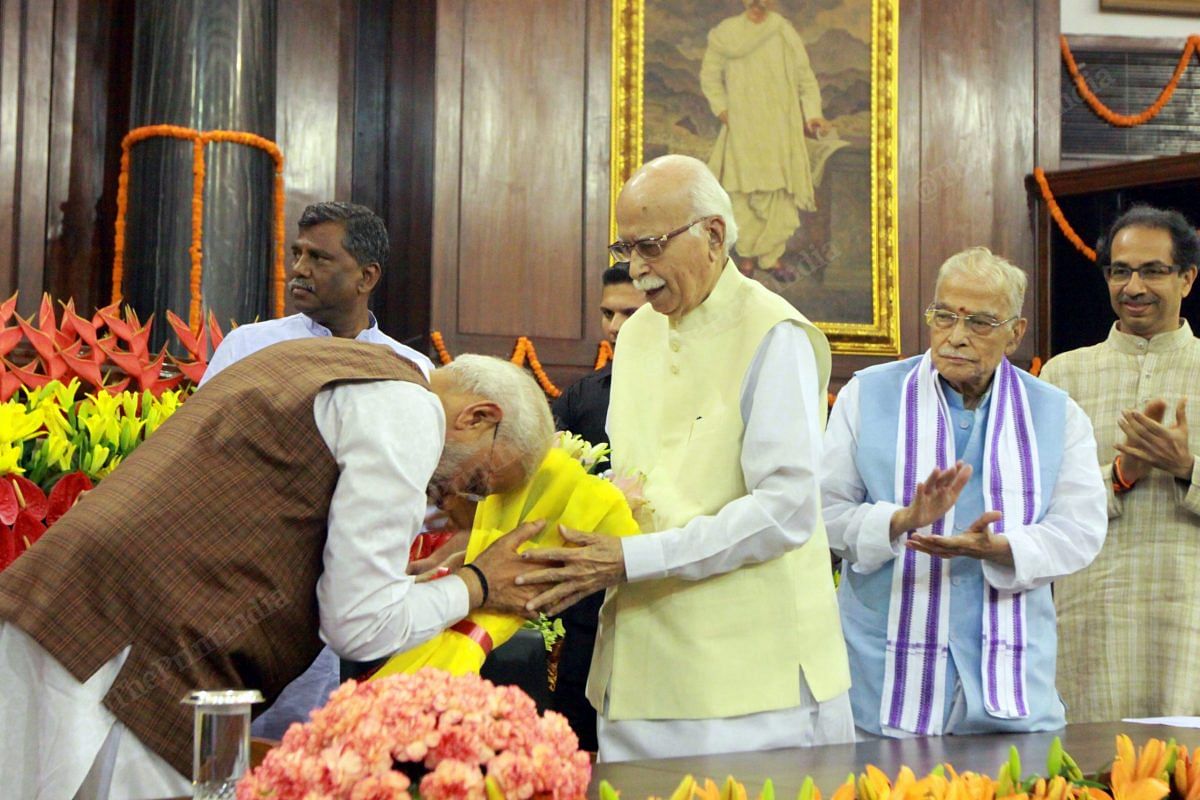L.K.Advani gives flowers to PM Modi after the party's win in the 2019 Lok Sabha elections | Photo: Praveen Jain | ThePrint