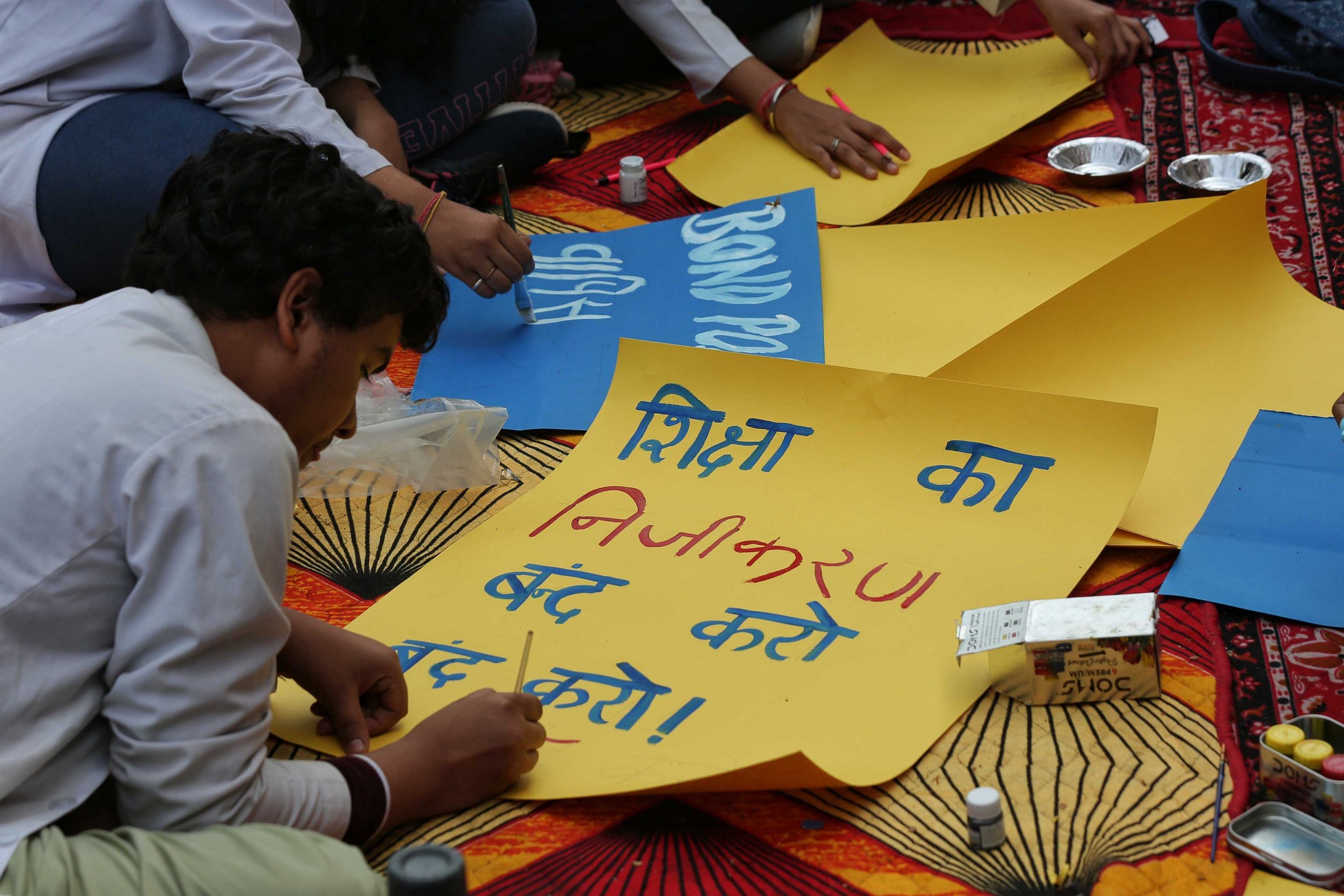 A medical student paints a poster during their silent protest at PGIMS-Rohtak on Sunday | The Print | Suraj Singh Bisht