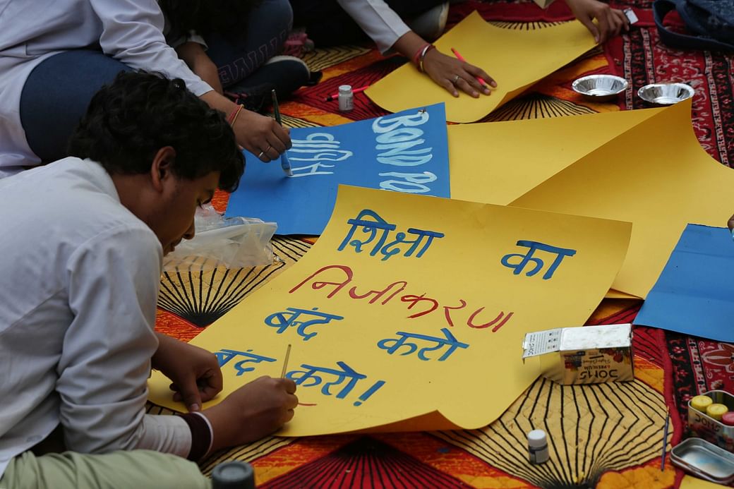 A medical student paints a poster during their silent protest at PGIMS-Rohtak on Sunday | The Print | Suraj Singh Bisht