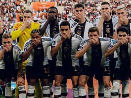 Germany players cover their mouths as they pose for a team group photo ahead of their game against Japan, on 23 November 2022 | Image via Twitter/@DFB_Team_EN