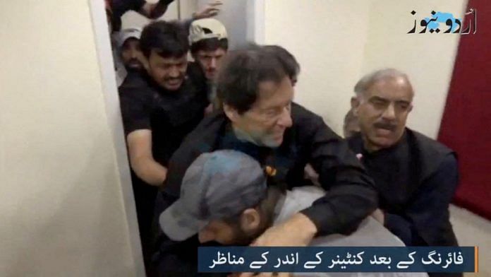 Former Pakistani Prime Minister Imran Khan is helped after he was shot in the shin in Wazirabad in this still image obtained from video | Urdu Media via Reuters