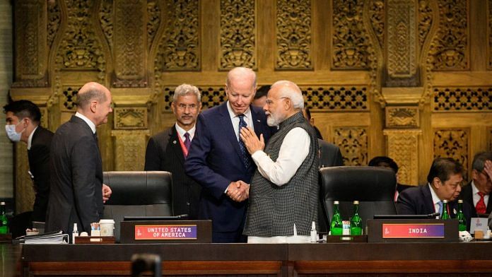 PM Narendra Modi and US President Joe Biden chat ahead of a working session on food and energy security during the G20 Summit, on 15 November 2022 | Leon Neal/Pool via Reuters