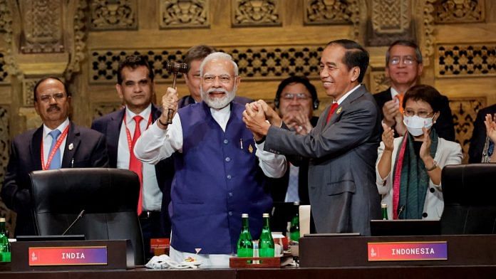 PM Narendra Modi and Indonesia's President Joko Widodo hold hands during the handover ceremony at the G20 Leaders' Summit in Nusa Dua, Bali, on 16 November 2022 | Reuters/Willy Kurniawan/Pool
