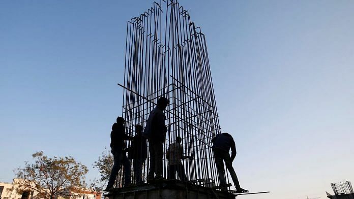 Workers build a pillar of a bridge on a national highway under construction in Ahmedabad | Reuters file photo/Amit Dave