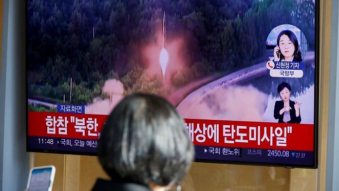 A woman watches a TV broadcasting a news report, on North Korea firing a ballistic missile off its east coast, in Seoul, South Korea, on 17 November 2022 | Reuters