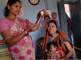 Representational image of a health worker giving vaccine to children
