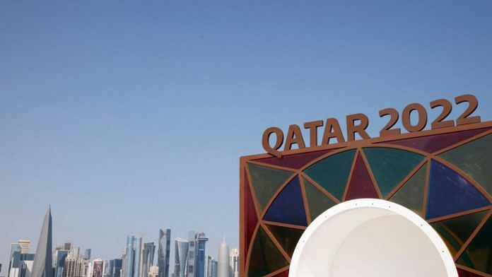 A Qatar 2022 logo is seen in front of the skyline of the West Bay in Doha, on 10 November 2022 | Reuters
