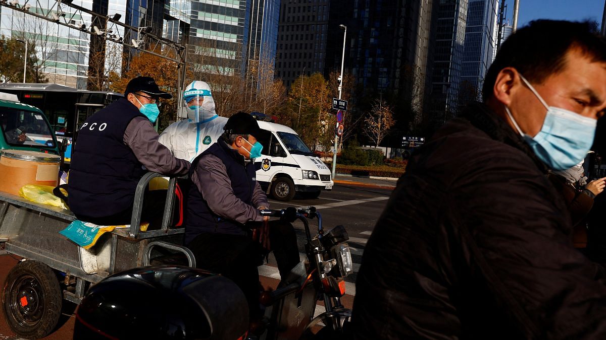 Untitled design - 2022-11-21T101510.252 A worker in a protective suit seen on a street during morning rush hour, following the outbreak of the coronavirus disease (COVID-19), in Chaoyang District, Beijing, China 21 November, 2022 | Reuters