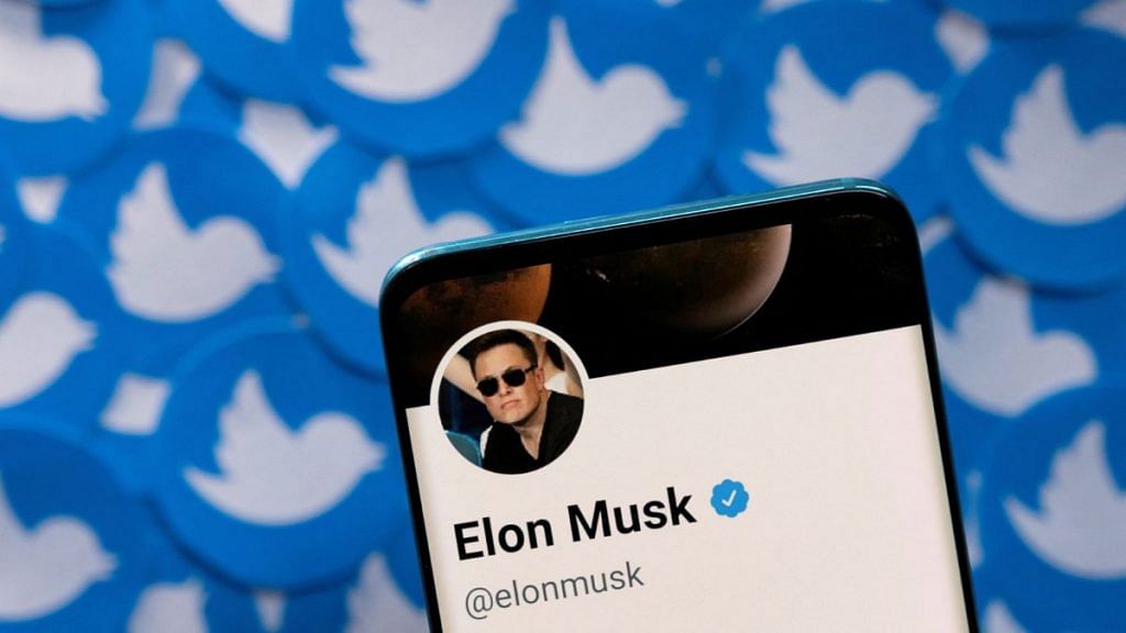 File photo of Elon Musk's Twitter profile as seen on a smartphone placed on printed Twitter logos taken pn 28 April, 2022 | Reuters