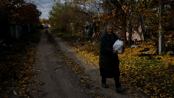 A woman walks after receiving aid, as Russia's invasion of Ukraine continues, in the eastern Donbas region of Drobysheve, Ukraine 31 October, 2022. Reuters/Clodagh Kilcoyne
