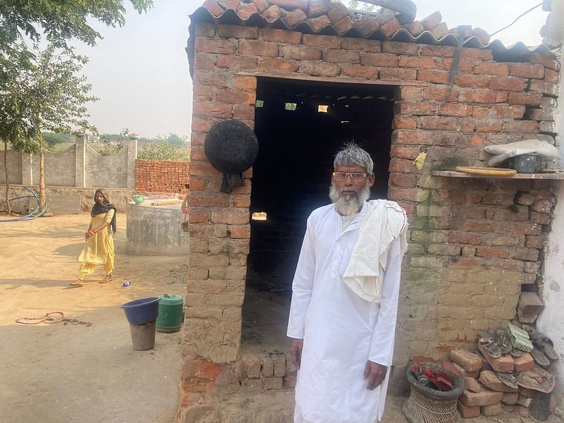 Ayub, Wahid's father, outside their kitchen | Vandana Menon