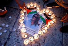 People light candles during a vigil in memory of Al Jazeera journalist Shireen Abu Akleh | Reuters File Photo/Mussa Qawasma