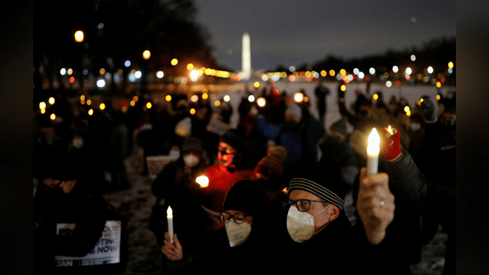 Representational image of people holding up candles during a candlelight vigil | Reuters File Photo/Tom Brenner