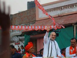 Home minister Amit Shah waves at voters during a roadshow in Ahmedabad Wednesday | Photo: Praveen Jain | ThePrint