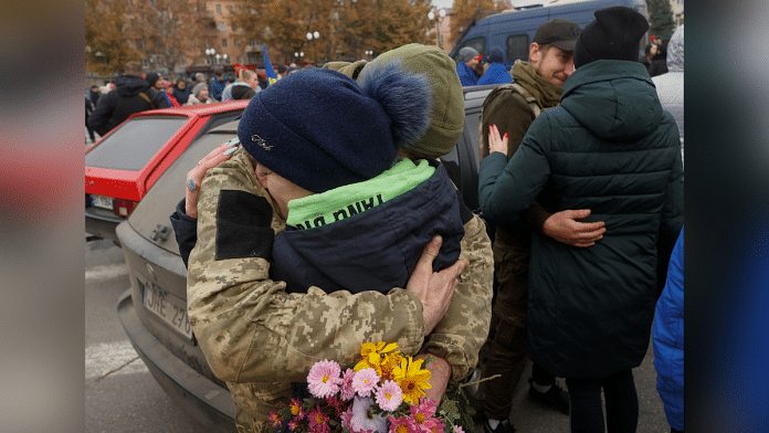 A local resident hugs a Ukrainian serviceman after Russia's retreat from Kherson | Reuters/Valentyn Ogirenko